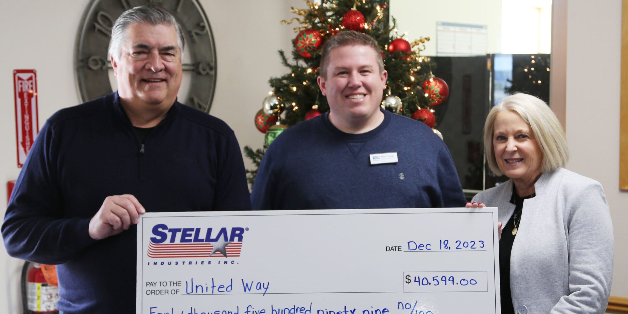 Stellar employees presenting a large check to United Way
