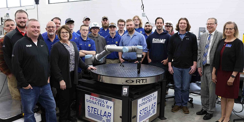 NIACC Robotics Program students and staff with Stellar employees gathered around the UR10 Collaborative Robot