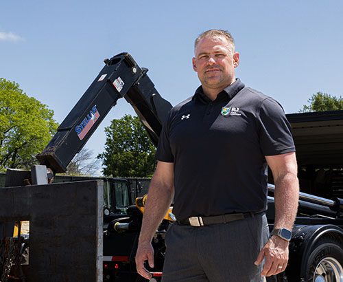 Man in black shirt standing in front of a black stellar work truck
