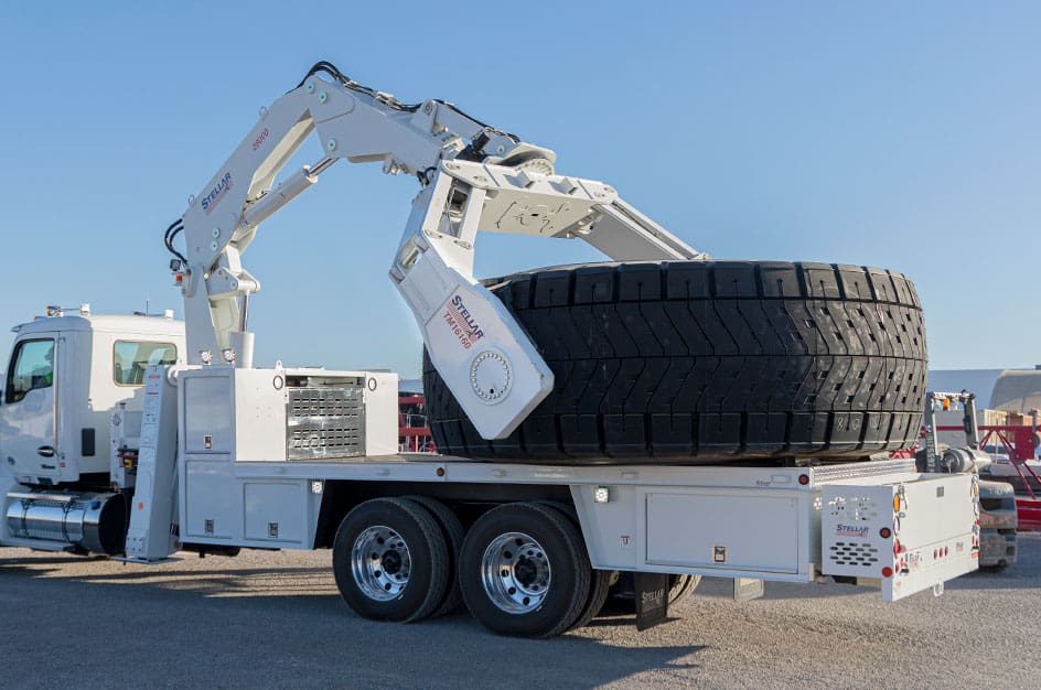 Stellar Tire Manipulator lifting a large tire.