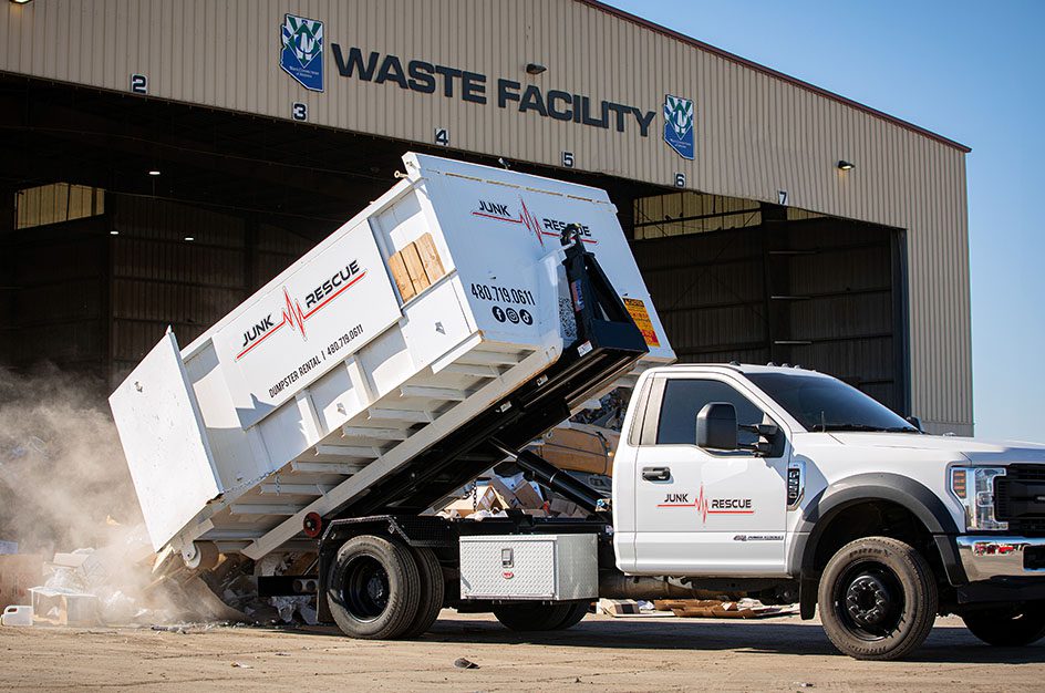 Junk Rescue truck offloading in front of waste facility